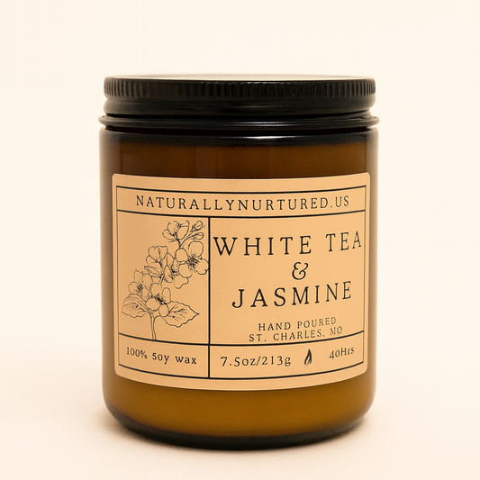 Candle jar labeled 'White Tea & Jasmine' by NaturallyNurtured.US on a beige background